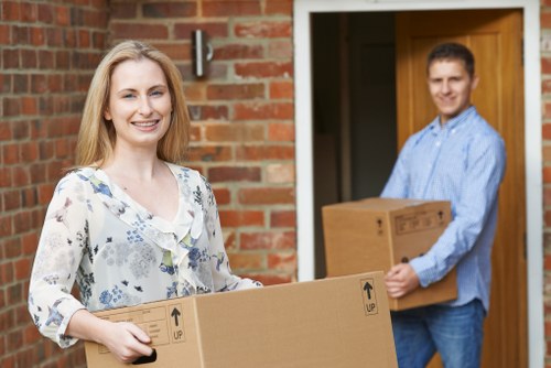 Removal movers carrying furniture during a Sidcup home move